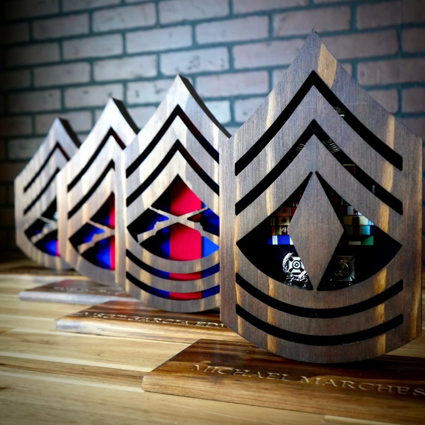 Marine Corps rank desk cases in wood, displaying military ribbons and badges